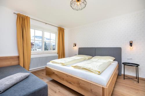 a bedroom with a large bed and a window at Chalet Sonnrain in Sankt Martin am Tennengebirge