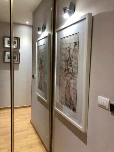 a hallway with two framed pictures on a wall at O recuncho in Monforte de Lemos