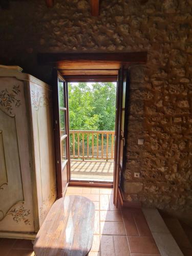 an open door in a room with a wooden porch at Pyrgos 1869 with Private Pool in Gythio