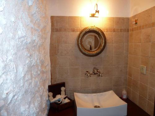 a bathroom with a sink and a mirror at Pyrgos 1869 in Gythio