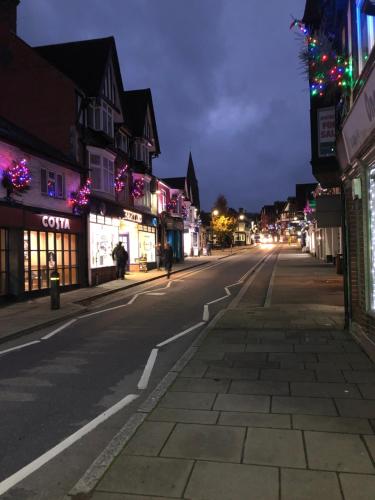 an empty city street at night with christmas lights at Spire View - New Forest Holiday Home in Lyndhurst