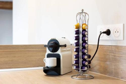 a coffee maker sitting on a table with a cup at Suite & Spa Maison de charmes avec Sauna & Hammam in Audrieu