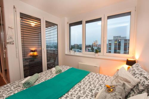 a bedroom with a bed and a window with a view at Sea Sun & Me Apartment in Koper