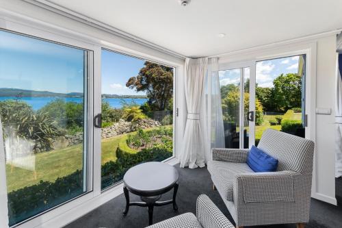 a living room with a view of the ocean at Black Swan Lakeside Boutique Hotel in Rotorua