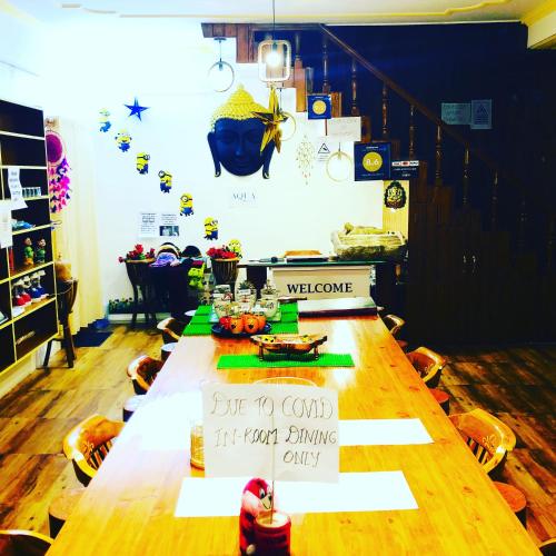 a long table with a welcome sign on it at Aqua De Vida in Bhowāli