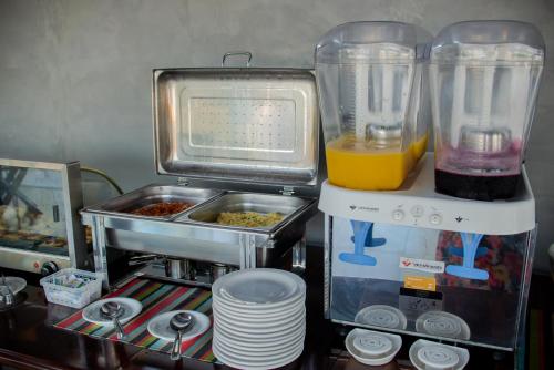 a kitchen with a blender and some food in it at Pousada Cabanas Kaia Lua in Praia do Rosa