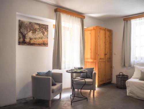 a living room with two chairs and a table at St. George Studios in Rhodes Town