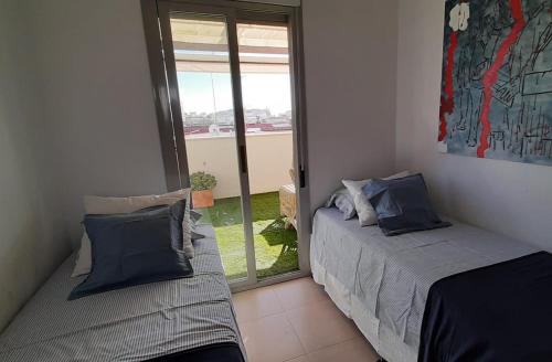 Posteľ alebo postele v izbe v ubytovaní Ático con vistas a la ría de Punta Umbría