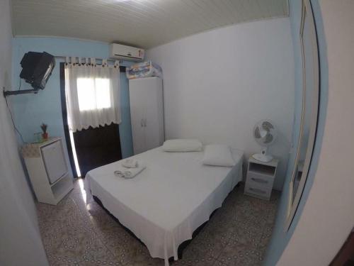 Säng eller sängar i ett rum på Hotel Ilha Bella