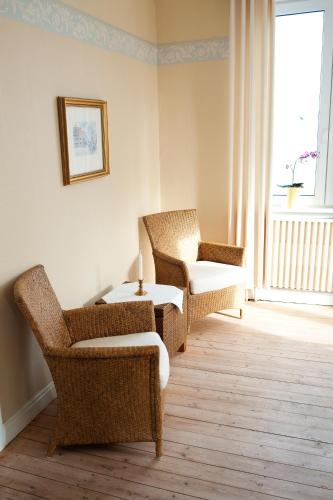 a room with chairs and a table and a window at Reftele Wardshus in Reftele