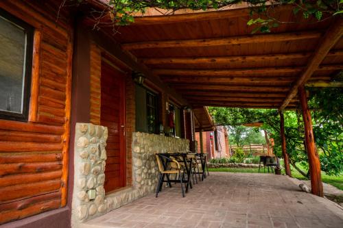 a porch of a house with a wooden pergola at Cabañas Abigail in Nono