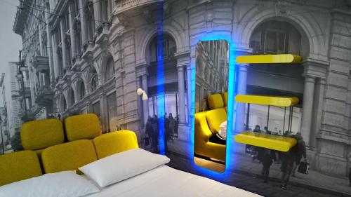 a bedroom with a yellow bed and a mirror at The Street Milano Duomo | a Design Boutique Hotel in Milan