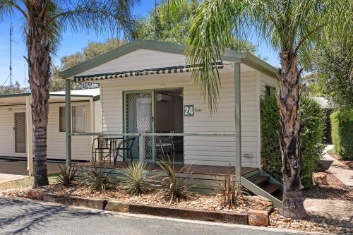 a house with a porch with palm trees at BIG4 Moama Holiday Park in Moama