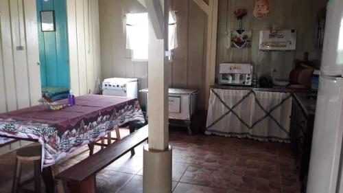 a kitchen with a table and a kitchen with a stove at Sítio para Famílias em Pomerode - Santa Catarina in Pomerode