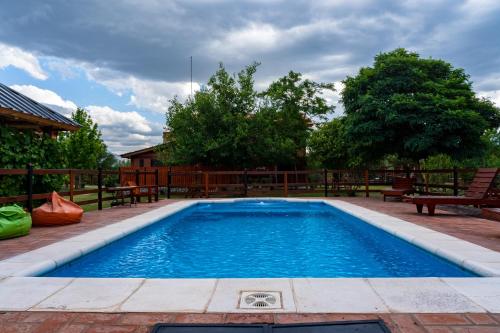 una piscina en un patio con bancos alrededor en Cabañas Abigail en Nono