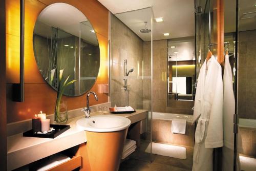 a bathroom with a sink and a mirror at The Gardens – A St Giles Signature Hotel & Residences, Kuala Lumpur in Kuala Lumpur