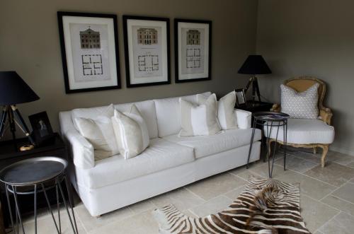 a living room with a white couch and a zebra rug at Ngamihi Lodge in Rotorua