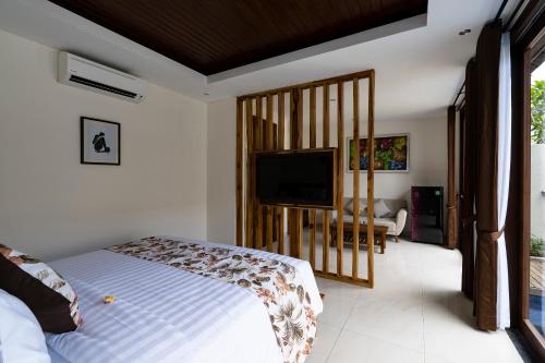 Ένα ή περισσότερα κρεβάτια σε δωμάτιο στο The Calna Villa Bali