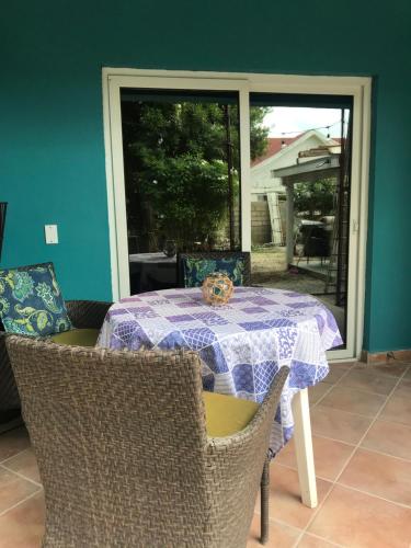 a table with a purple table cloth on it with chairs at Apartment Star 39 in Oranjestad