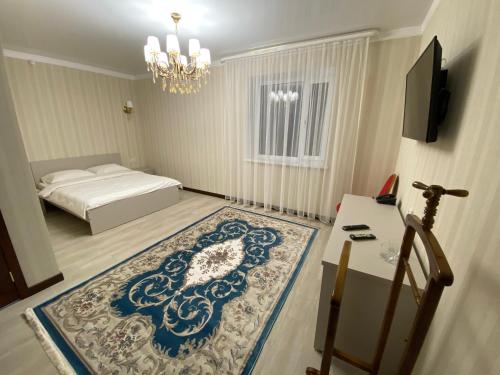 a bedroom with a bed and a large rug at Hotel Astam in Kostanay