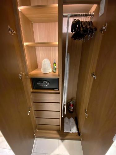 a kitchen with a cupboard with a sink and a refrigerator at Ascott Marunouchi Tokyo in Tokyo