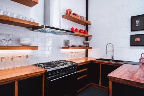 a kitchen with a black stove and a sink at Union Street - Central Castlemaine Pad in Castlemaine
