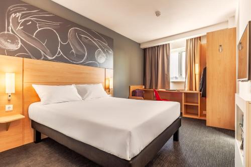 a hotel room with a large bed in a room at Ibis Krasnodar Center in Krasnodar
