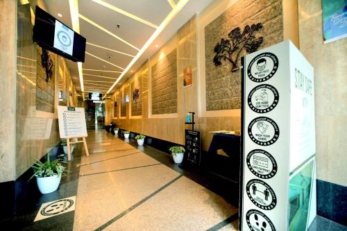 a hallway of a building with clocks on the wall at The Fern Residency Kolkata in Kolkata