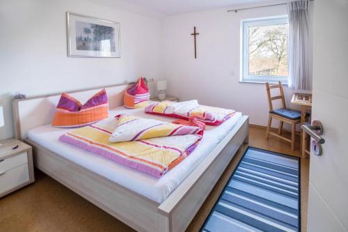 a bedroom with a bed with pillows on it at Haus Ruther - Wohnung 2 in Bad Saulgau