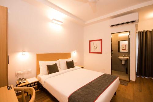 En eller flere senger på et rom på Hotel Vemara