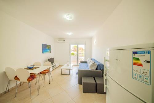 a kitchen and living room with a refrigerator and a table at Modern Apartment in Vrsi, 45 m², spacious terrace in Vrsi