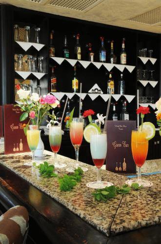 a group of wine glasses sitting on top of a bar at Hotel du Parc in Tunis
