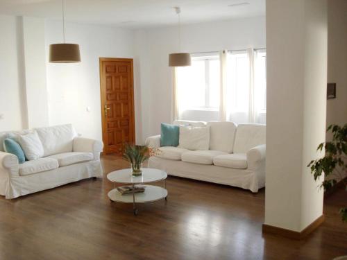 a living room with two white couches and a table at Spacious Apartment in Icod de los Vinos - Sea View 157 m² in Icod de los Vinos