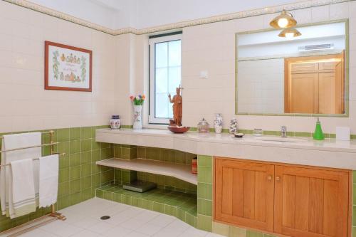 a bathroom with a sink and a mirror at Sunny Villa in Comporta with Private Pool in Montalvo