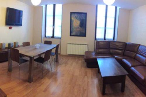 a living room with a couch and a table at Appartement de 3 chambres avec wifi a Roanne in Roanne