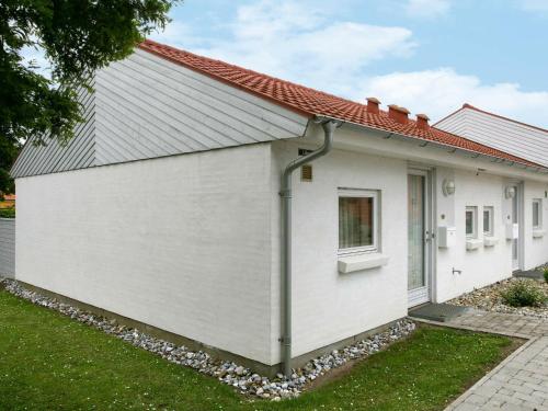 a white house with a red roof at 4 person holiday home in r sk bing in Ærøskøbing