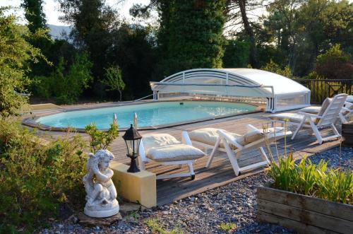 einen Pool mit Stühlen und einem Pavillon in der Unterkunft Villa de 4 chambres avec piscine privee jardin amenage et wifi a La Mole in La Môle