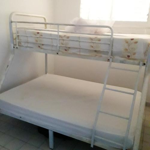 a white bunk bed in a room with a window at Appartement de 2 chambres avec vue sur la mer et jardin clos a Le Moule a 1 km de la plage in Le Moule