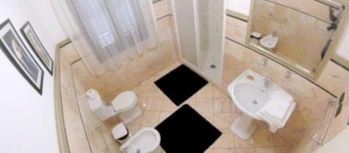 a bathroom with a toilet and a sink at Modern Apartment in Boca Chica, 130 m², Air Conditioning Included in Boca Chica