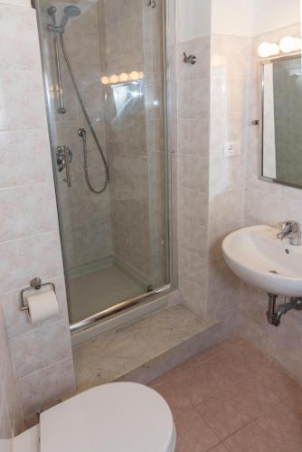 a bathroom with a shower and a toilet and a sink at Luxury Seaview Apartments Manarola by Arbaspàa in Manarola