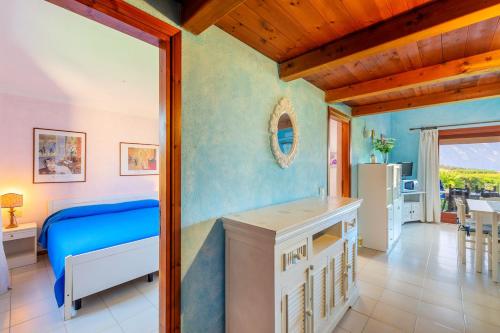 a bedroom with a bed and a table in a room at Spacious Apartment in San Teodoro with Garden and Parking in San Teodoro