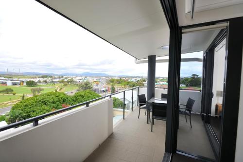 a balcony with a table and chairs and a view at Apartments G60 Gladstone in Gladstone