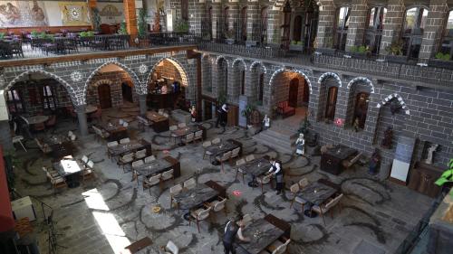 an overhead view of a building with tables and chairs at The Green Park Diyarbakir in Diyarbakır