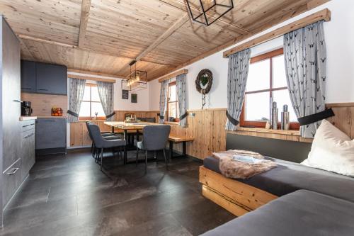 a room with a bed and a kitchen with a table at Bergchalet am Hochkönig in Mühlbach am Hochkönig