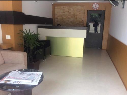 a living room with a person walking into a building at HISHAM SUITES in Ernakulam
