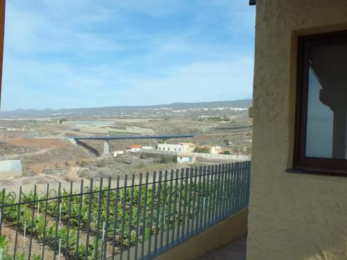a balcony with a view of a vineyard at La Cabaña in Guía de Isora
