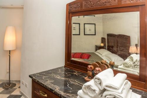 a bedroom with a bed and a large mirror at Luxury Seaview Apartments Manarola by Arbaspàa in Manarola