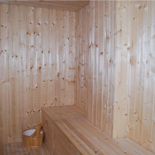 a wooden sauna with a toilet in the corner at MCITI Suites in Miri
