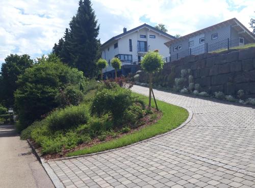a brick driveway in front of a house at Limes Apartment -übernachten am Limes- in Rainau