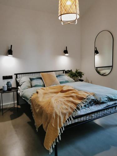 a bedroom with a bed with a fur blanket on it at Domki MODERN Jezioro Nyskie in Nysa